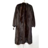 A 'Higg's Furs' full length dark mink coat, the lining heavily embroidered with flowers, together