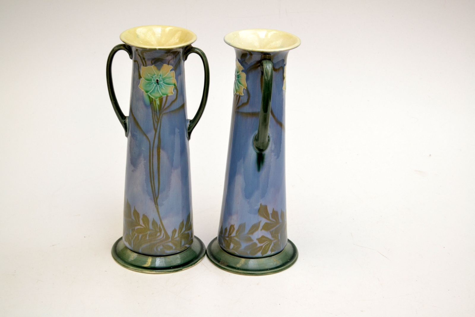 A pair of Minton Secessionist twin handled slightly tapering vases, model number 3536, with mottled,