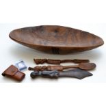 A native carved wood salad bowl and servers, together with an African figure carved letter knife,