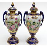 A pair of Japanese twin handled lidded vases in Serves style, painted with flowers.