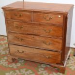 A George III chest of two short and three long graduated cock beaded drawers flanked by canted,