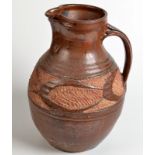 A tenmoku glazed stoneware jug in Abuja style with carved shoulder, height 29.5cm.