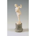 A 1930s ivory carving of a scantily clad dancing girl, signed Fritsch, height including marble socle