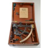 A late 19th to early 20th century sextant with a brass and silvered scale and rosewood handle in a