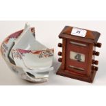 A mahogany small perpetual calendar together shards of a Chinese bowl.