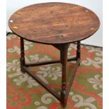 A rare 18th century small elm cricket table on three turned legs joined by stretchers.  Diameter