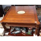 A coffee table by Frank Hudson & Company inset with a reproduction scrimshaw of a sailing ship,