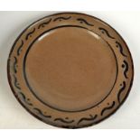 A rare early Bernard Leach plate, the rim with simple iron brushwork, painted B.L. monogram and