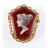 A Limoges pendant/brooch with a white classical female head on red ground.