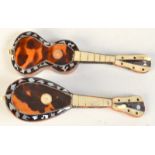 A miniature mandolin and a miniature guitar.