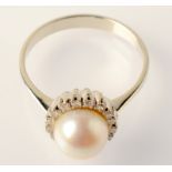 A pearl and diamond target ring.