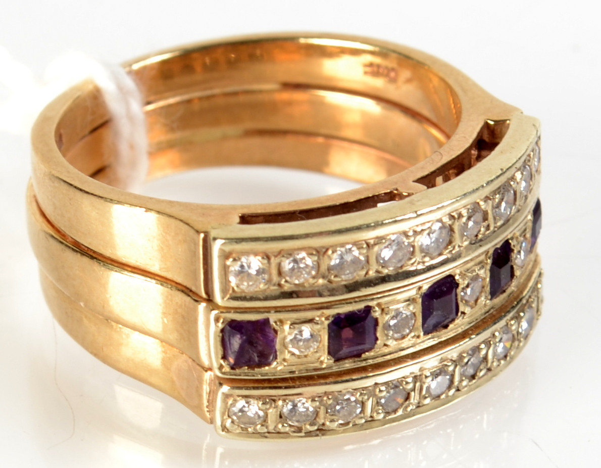 A triple banded 9ct gold ring set with diamonds and amethyst.   Condition Report: The ring is N/O,