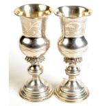 A pair of late 19th century Russian silver Kiddush style goblets with stepped bases and lightly