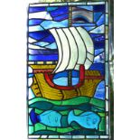 Three leaded stained glass panels, one with a shield measuring 110 x 51cm. a second lobed 72cm.