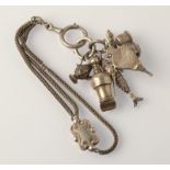 A silver watch chain mounted with silver fobs, including a kettle seal and a whistle.