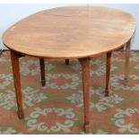 A George III mahogany, twin flap oval table, the square section tapering legs with inlaid lines.