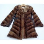 A Simpsons Fur Salon coat with leather side panels and belt, size 10 approx.