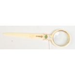 A fine ivory magnifying glass/letter opener mounted with engraved gold and set with jade.