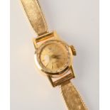 A ladies Rolex, gold cased Orchid wristwatch on woven 9ct. gold strap. Condition Report: Weight 16.3