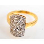 An 18ct ring set with two principle diamonds on a pave set ‘S’ ground. Condition Report: Good