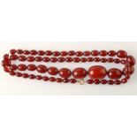 A "cherry amber" graduated bead necklace, 49g.