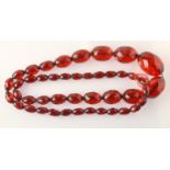 A faceted, graduated "cherry amber" necklace, 70g.