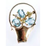 A gold basket brooch set with aquamarines and diamonds. Condition Report: Gold as hall marked