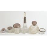 A collection of six cut glass and silver pieces including perfume bottles and trinket boxes.