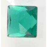 An unmounted, square cut simulated emerald.