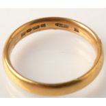 A 22ct. gold band, 4.9g.  Condition Report: The ring is O/P