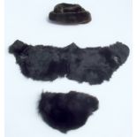 A beaver fur hat and one other fur hat, together with a fur wrap.