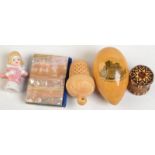 A Mauchline Ware egg shaped needlework case, related accessories and a porcelain half doll.