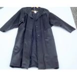 A full length black leather coat with incised sleeves and collar, size 46.