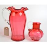 A cranberry glass, tall fluted jug with everted petal rim,