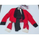 Two red military jackets, together with a pair of woollen trousers, etc.