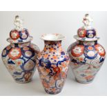 A pair of 19th century Imari lidded vases, height 47cm, together with a third Imari vase, damage,