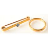 A 22ct. gold band, 4.7g., together with a gold bar brooch set a sapphire.  Condition Report: Size N