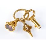 A gold Bramah key, a gold watch key together with a gold seal, on a gold ring. Condition Report: