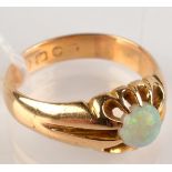 An 18ct. gold ring claw set an opal.