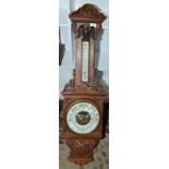 A late Victorian ornate carved aneroid barometer/thermometer.