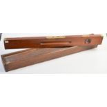 A brass mounted, mahogany, 30 inch spirit level by E Preston and Sons. With a pine protective case.