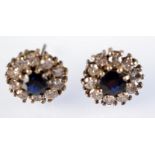 A pair of diamond and sapphire cluster earrings.