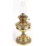 A brass oil lamp with a Messengers Annular burner. Condition Report: no shade, chimney lift works,