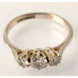 An 18ct. white gold and platinum three stone diamond ring.