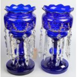 A pair of enamelled and gilt blue glass lustres, each with two rows of prismatic cut drops, height