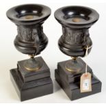 A pair of French black marble and bronze mounted urns. 26cm.