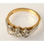 An 18ct. gold three stone diamond ring.