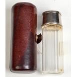 A small cut glass spirit flask with integral collapsible cup in leather case.