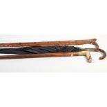 A stout malacca walking stick with antler handle together with a silver mounted walking stick and a