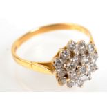 An 18ct diamond cluster ring. Condition Report: Image showing lead solder, one diamond missing,